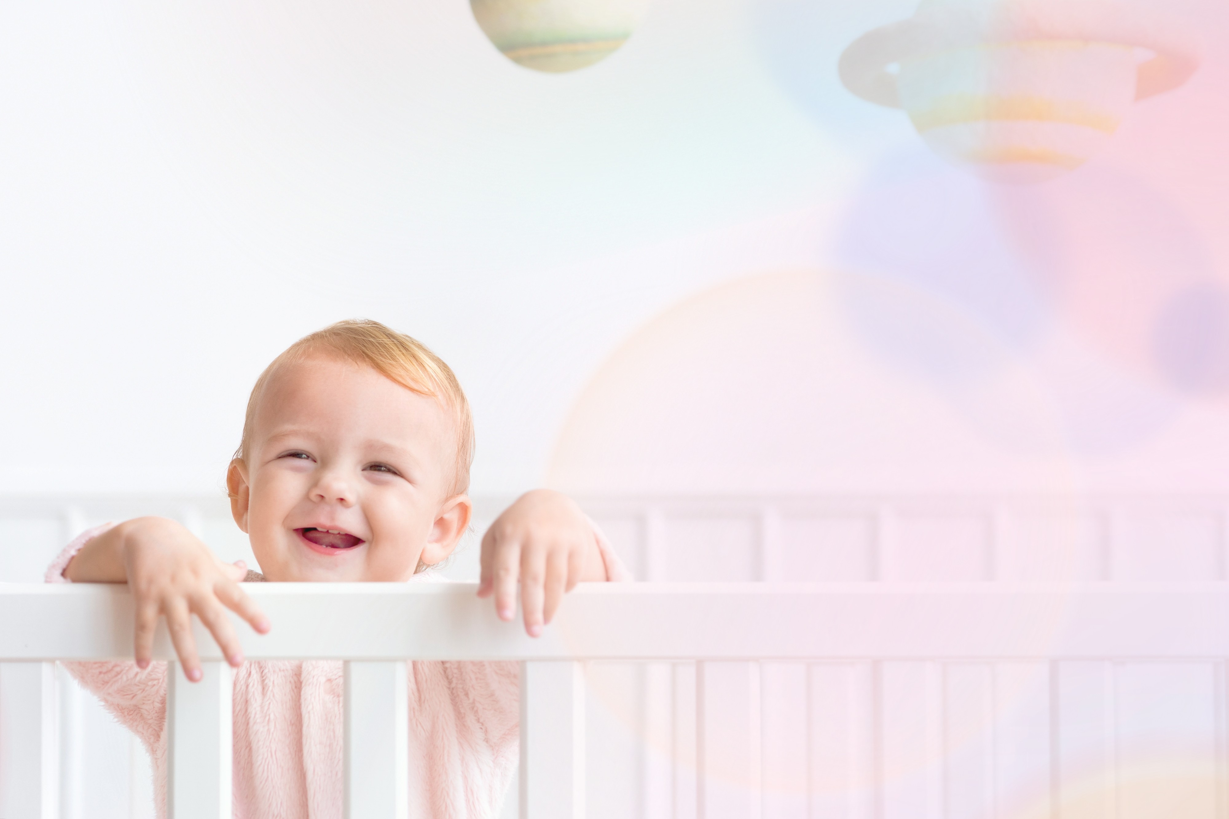 Happy baby in crib - baby name inspiration